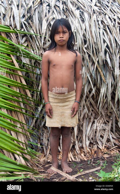 A Matses Mayorunas young girl in front of a maloca (traditional Stock ...