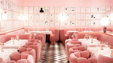 the interior of a restaurant with pink velvet booths and checkered ...