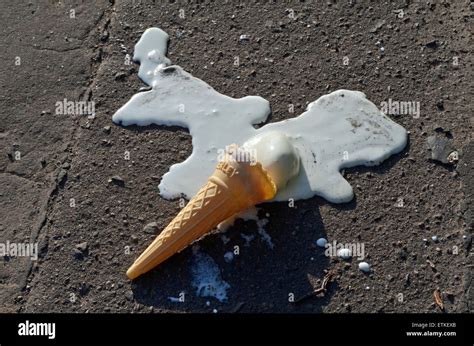 Melting ice cream cone on the pavement Stock Photo - Alamy