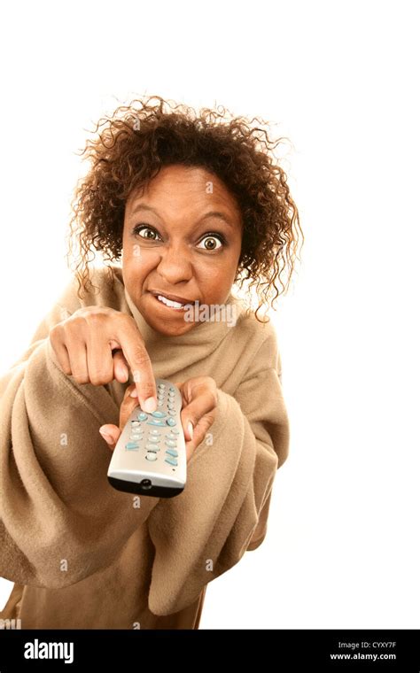 Woman holding TV remote wearing blanket with sleeves Stock Photo - Alamy