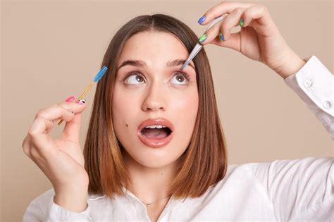 Premium Photo | Indoor shot of concentrated woman with tweezers and ...