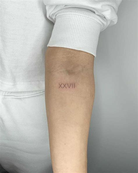 Roman numerals XXVII tattoo by Conz Thomas inked on the left forearm | Tattoos, Fine line ...