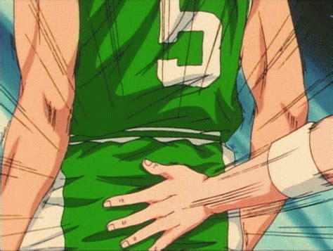 a man in a green jersey holding his hand on his hip