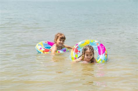 Premium Photo | Children swimming in the lake.