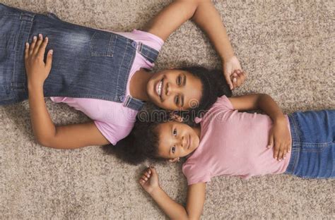 Teen and Little African American Girls Lying Together on Floor Stock Photo - Image of female ...