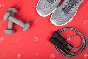 Sport Shoes, Dumbbells and Skipping Rope on Red Background. Top View. Fitness, Sport and Healthy ...