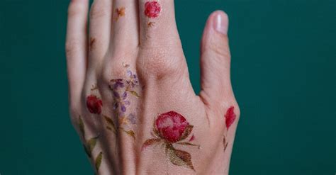 Photo of Flower Tattoos on Person's Left Hand · Free Stock Photo