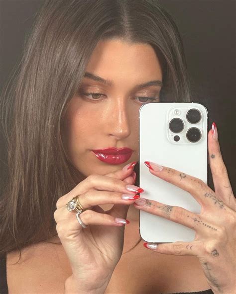 Hailey Bieber debuts festive holiday nails, matching red lipstick