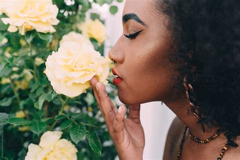 "A Young Black Woman Smelling A Yellow Rose" by Stocksy Contributor ...