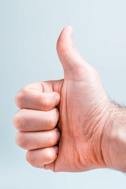 Premium Photo | Cropped hand showing thumbs up against white background