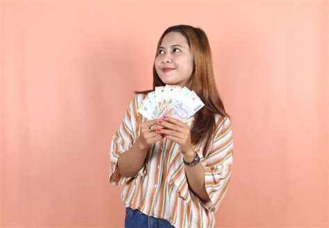 Premium Photo | Holding cash money in indonesian rupiah