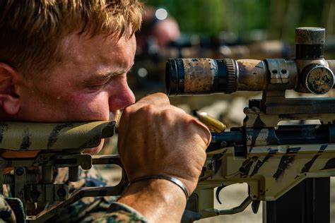 A U.S. Marine racks the bolt of an M40A6 sniper rifle during a bilateral sniper shooting package ...