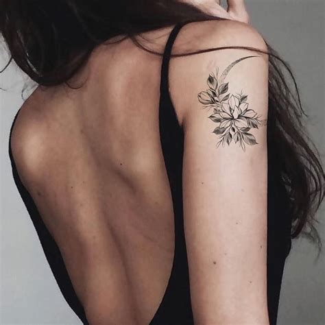 a woman with a flower tattoo on her left arm and right arm behind her back