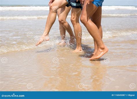 Friends Walking Along the Beach Stock Image - Image of barefoot, body: 116045087