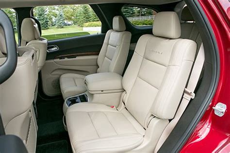 the interior of a red car with leather seats