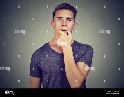 Young man trying to whistle isolated on gray wall background Stock Photo - Alamy