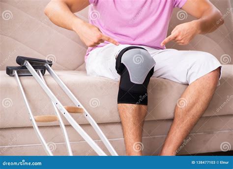 The Young Man with Injured Knee Recovering at Home Stock Image - Image of physiotherapy, joint ...