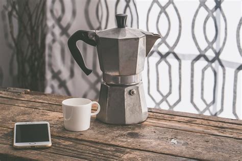 Gray Moka Pot Beside White Ceramic Cup on Brown Wooden Table · Free Stock Photo