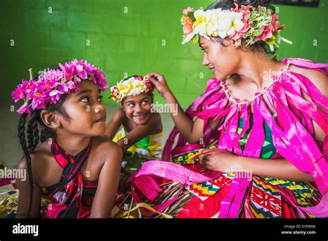 A Tuvalu woman with two young girls dressed in traditional costume ...