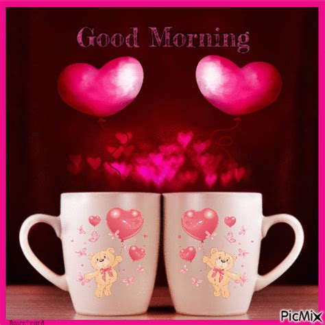 two coffee mugs with hearts on them and the words good morning written in pink