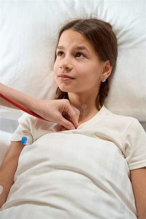 Teenage Girl Lies on Bed with Thermometer Under Her Arm Stock Photo - Image of comfortable ...