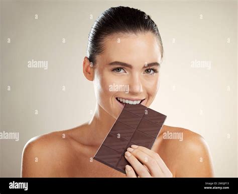 Beauty portrait, eating and woman with chocolate, junk food or dessert for sugar sweets, candy ...