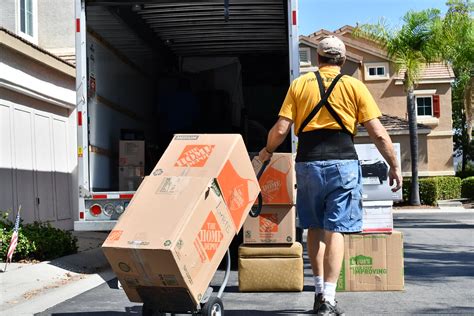 Mover Loading Boxes onto Truck | Male mover wearing a yellow… | Flickr