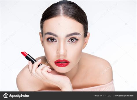Woman holding red lipstick — Stock Photo © DmitryPoch #141417232