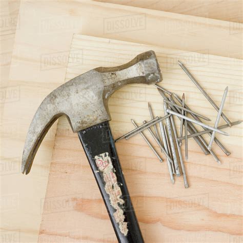 Close up of hammer and nails - Stock Photo - Dissolve