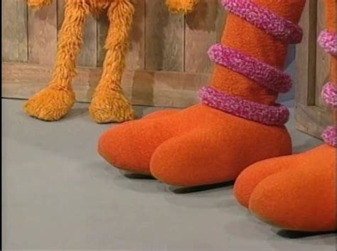 two orange stuffed animals standing next to each other