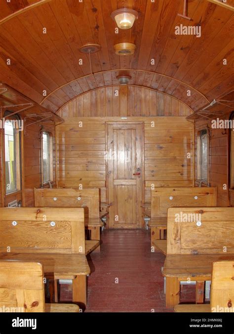 The interior of a historic passenger rail car. The interior has wooden ...