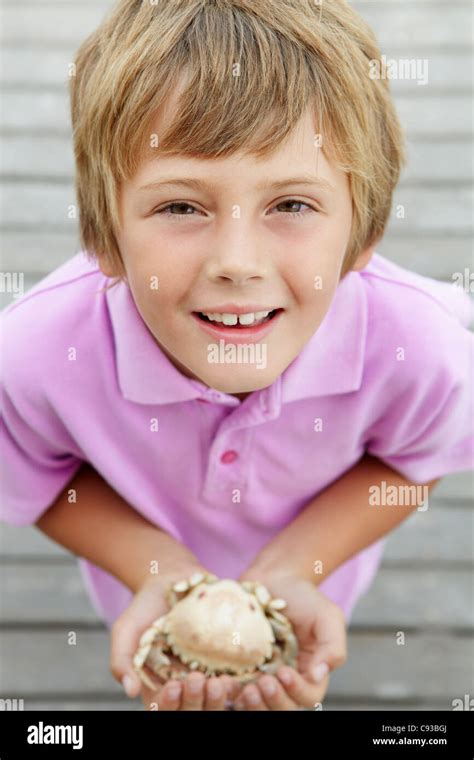 Young boy holding crab Stock Photo - Alamy