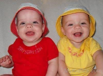 Twin Baby Wearing Red And Yellow Dress