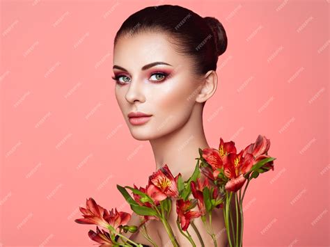 Premium Photo | Portrait of beautiful young woman with Alstroemeria flowers