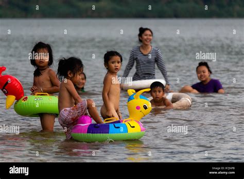 Don Daeng, Laos - April 27, 2018: Local people swimming in the Mekong river at sunset Stock ...