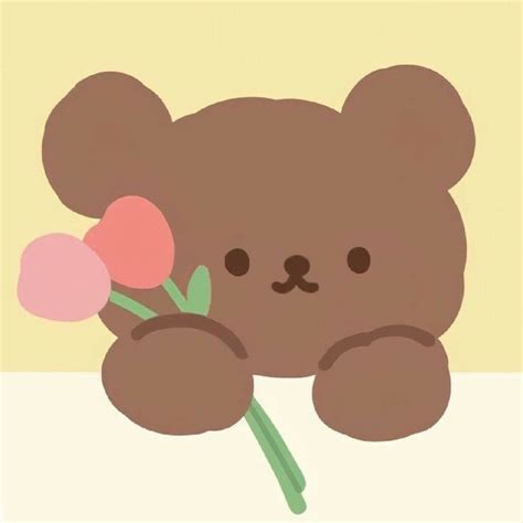 a brown teddy bear holding flowers in its paws