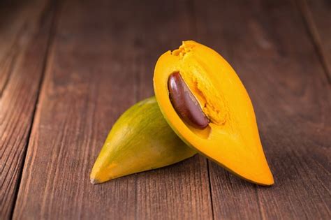 Premium Photo | Egg fruit canistel yellow sapote on dark background.