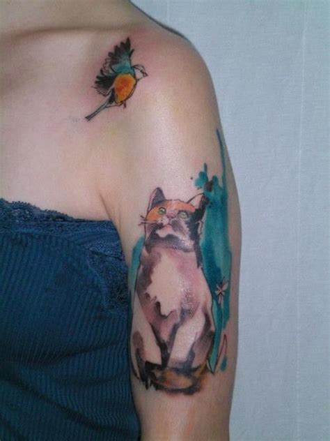 Cat and bird watercolor tattoo on arm | Bird shoulder tattoos, Watercolor bird tattoo ...