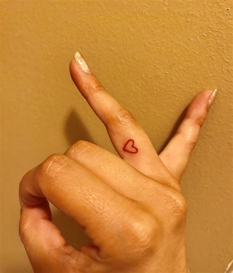 Red heart finger tattoo ♥️ | Heart tattoo on finger, Red heart tattoos, Small finger tattoos