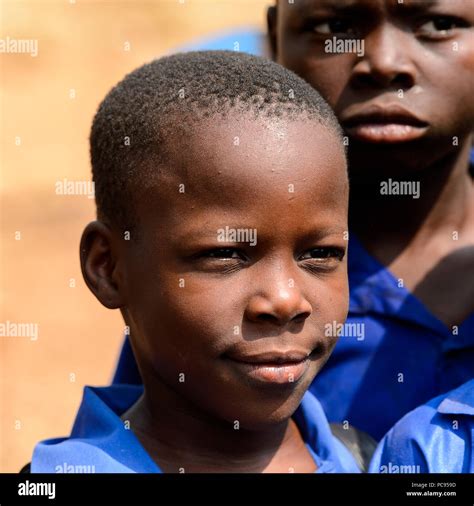PIRA, BENIN - JAN 12, 2017: Unidentified Beninese little boy in a blue school uniform. Benin ...