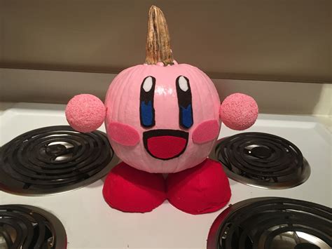 Nintendo's Kirby pumpkin, made with paint, felt, Styrofoam balls, and glue. Hands and feet held ...