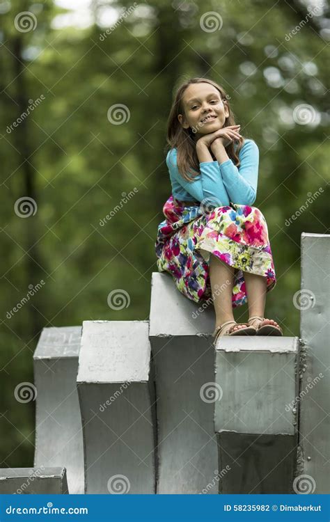 Little Cute Girl Sitting Outdoors. Happy. Stock Photo - Image of green, adorable: 58235982