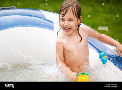 The little girl plays in inflatable pool a sunny day Stock Photo - Alamy