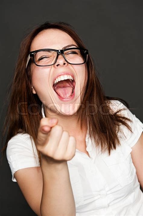 Woman pointing finger and laughing | Stock image | Colourbox