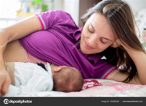 Young mother breastfeeding her newborn baby boy Stock Photo by ©t.tomsickova 166385346