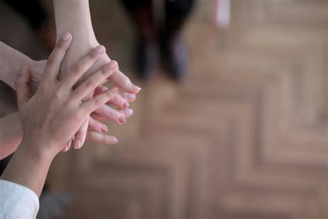 Crop group stacking hands together · Free Stock Photo