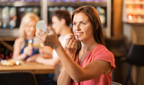 Woman with Lipstick Applying Make Up at Restaurant Stock Image - Image of coloring, lipstick ...