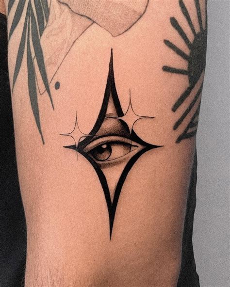 a man's arm with an eye tattoo on it