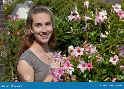 Teenage Girl and Pink Mandevilla Stock Image - Image of beautiful, house: 125925569