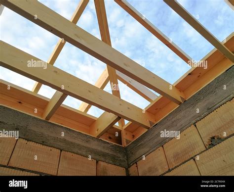 Wood girder beams for new roof construction at construction site Stock Photo - Alamy